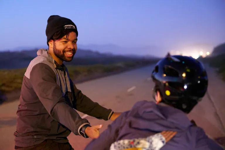 Cardayell on his bike wearing a PORTOLA hat on Ocean Beach Park