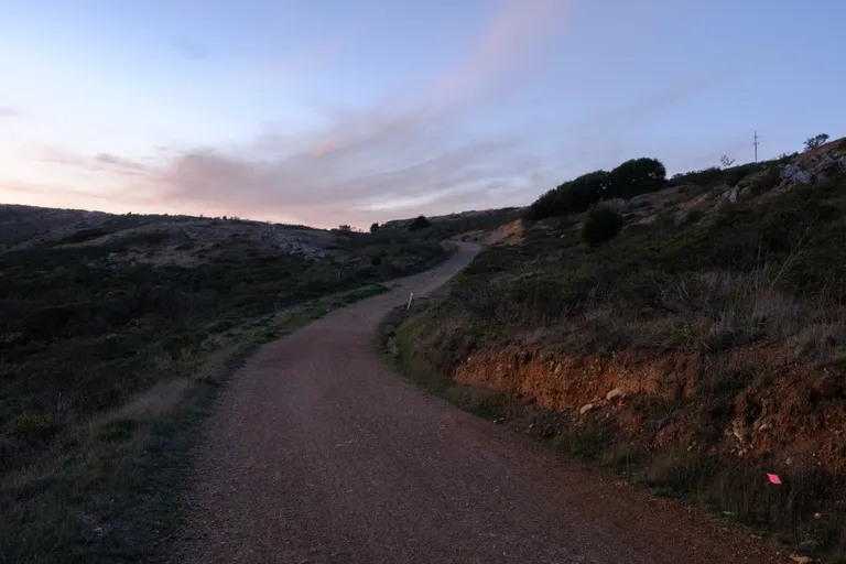 A dim trail with the sunset in the background
