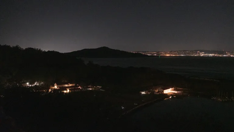 A view of Angel Island in the dark with the East Bay behind it