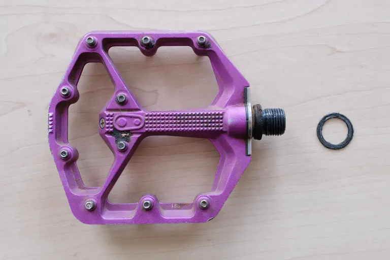 A Crankbrothers Stamp 7 right pedal with pedal washer. Lots of grease and dirt