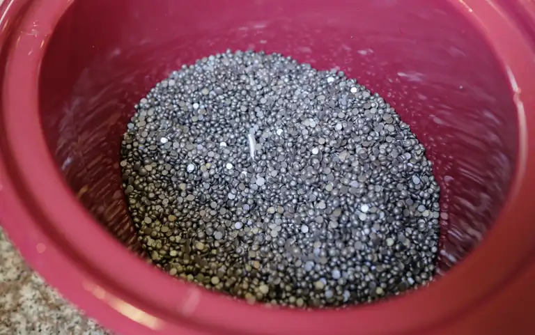 Hundreds of wax pellets sitting in a slow cooker