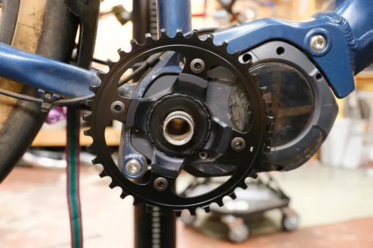 A new black chainring installed on an e-bike motor unit