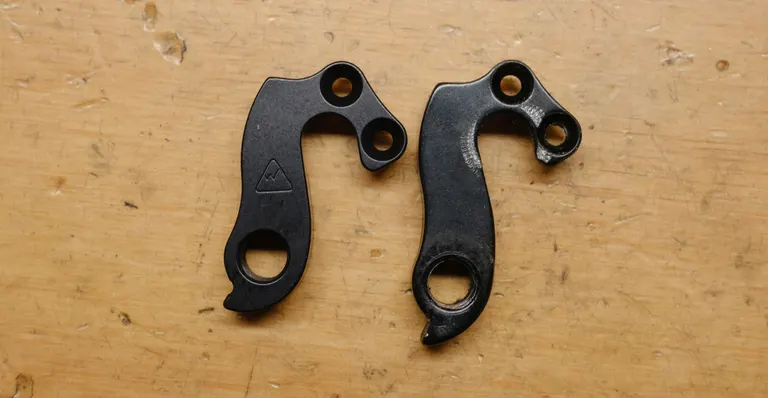 The new and old derailleur hanger side by side. The new one is shorter and has more material around the derailleur mount.