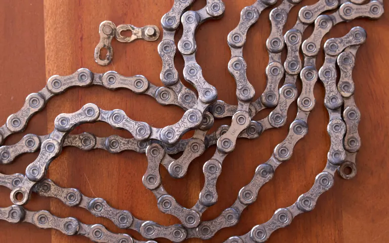 Close overhead of a chain with dried, dirty wax on it