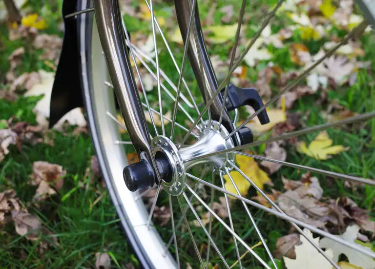 The front hub of a Brompton 16 inch wheel in its fork.
