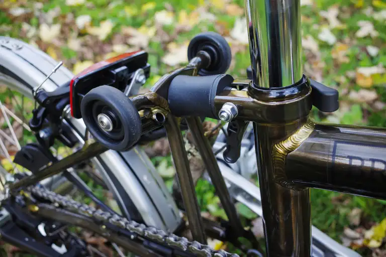 The rubber bumper between the rear triangle hinge and seat tube.