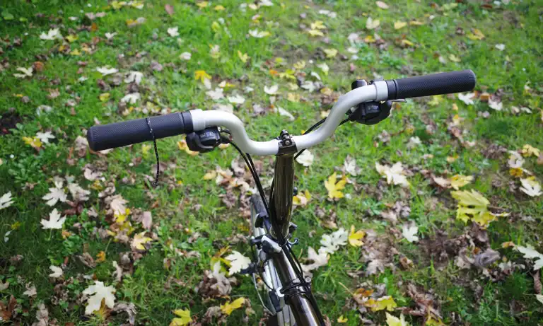 The high handlebars of a Brompton, looking from where the rider would be sitting.